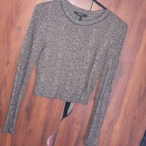 Long sleeved, cropped top.